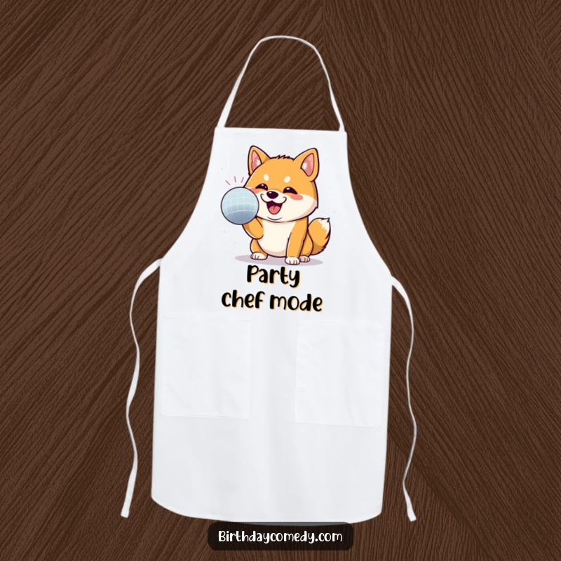 Funny Shiba Inu apron depicting a Shiba Inu with a determined grin, attacking a disco ball, ready for a kitchen party.