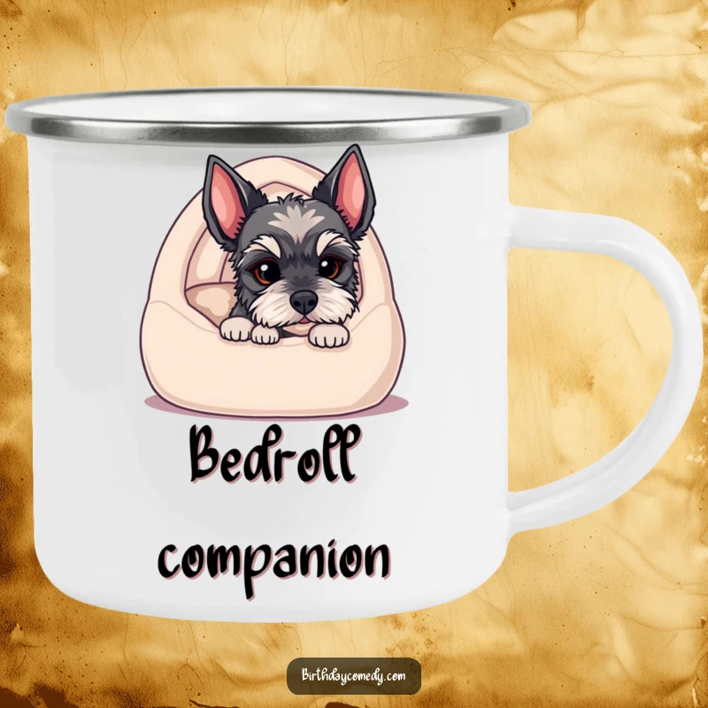 Funny camping mug depicting a schnauzer puppy peeking from a cozy bed, ready for outdoor adventures and lots of smiles.