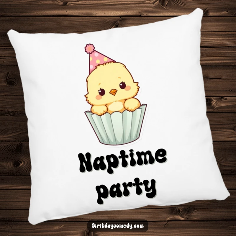 Funny fluffy chick wearing a party hat peeks out of a cupcake wrapper, a soft pillow for cozy moments.