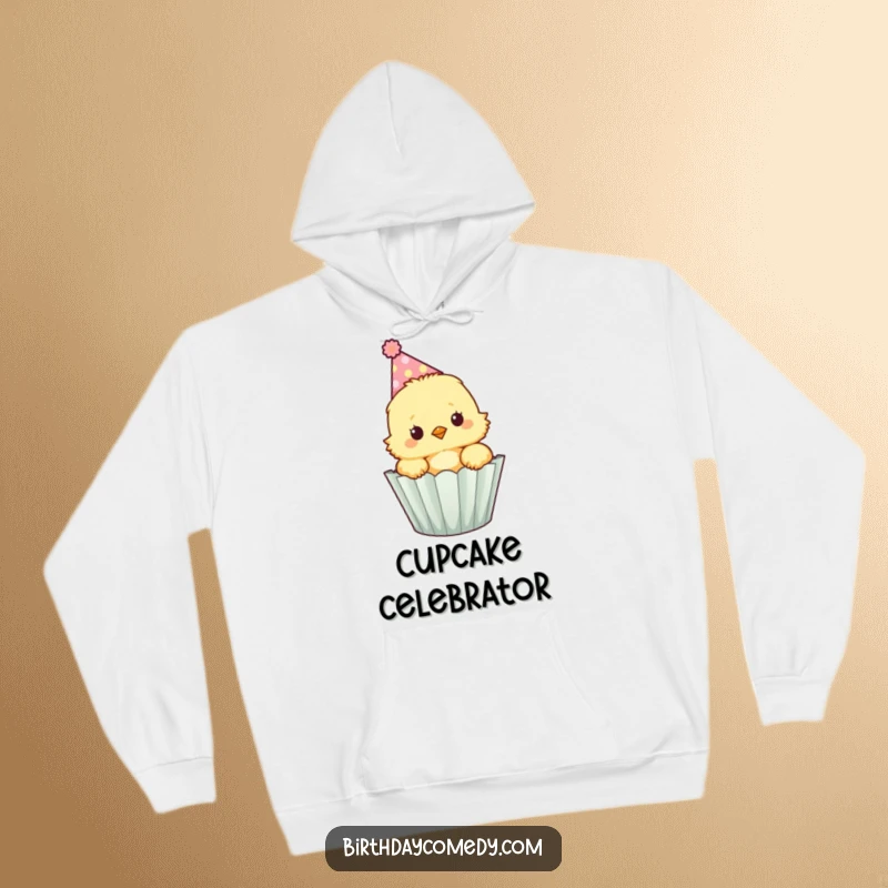 Funny fluffy chick wearing a party hat peeks out of a cupcake wrapper, a warm and cute hoodie.