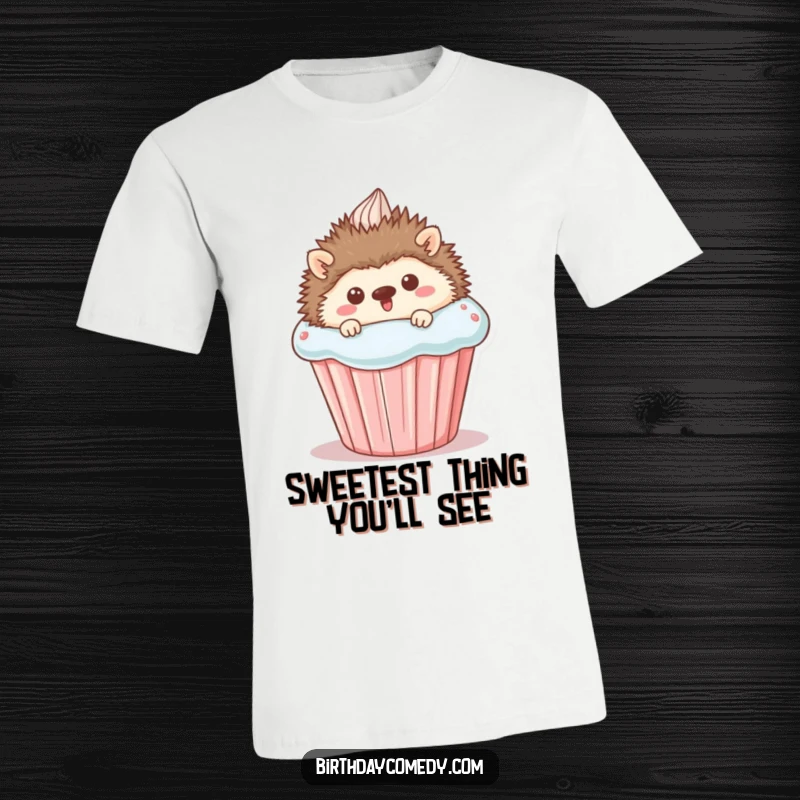 Funny T-Shirt: A happy hedgehog peeking from behind an oversized cupcake, embodying cuteness and a love for delicious desserts.