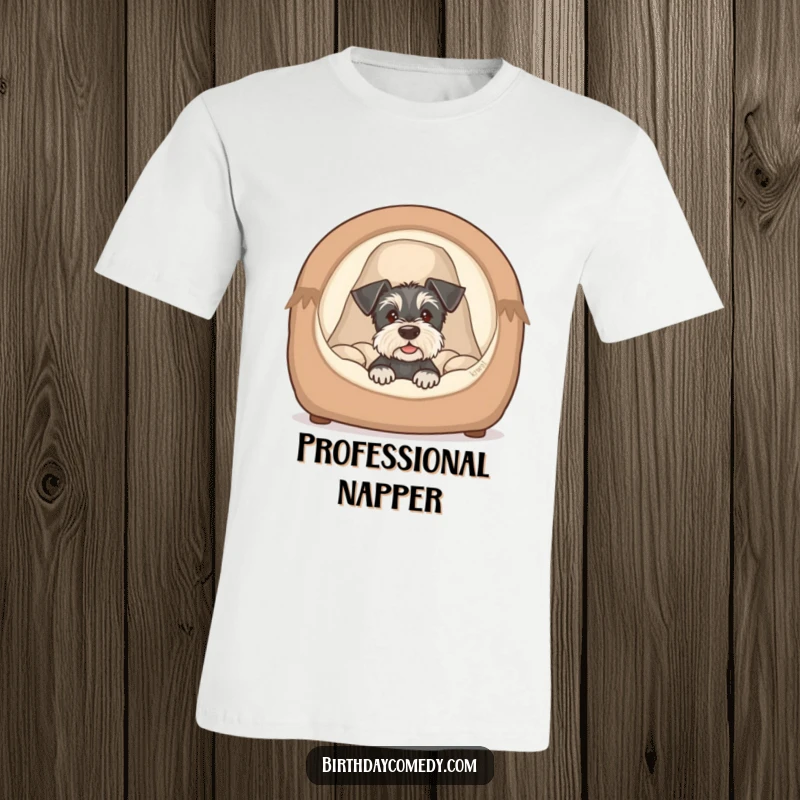 Funny schnauzer puppy t-shirt showing a cute dog peeking from a cozy bed, a humorous and endearing design.